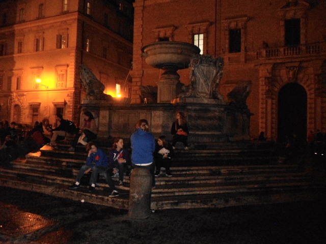 Young people gathering at the fountain in Piazza Santa Maria in Trastevere